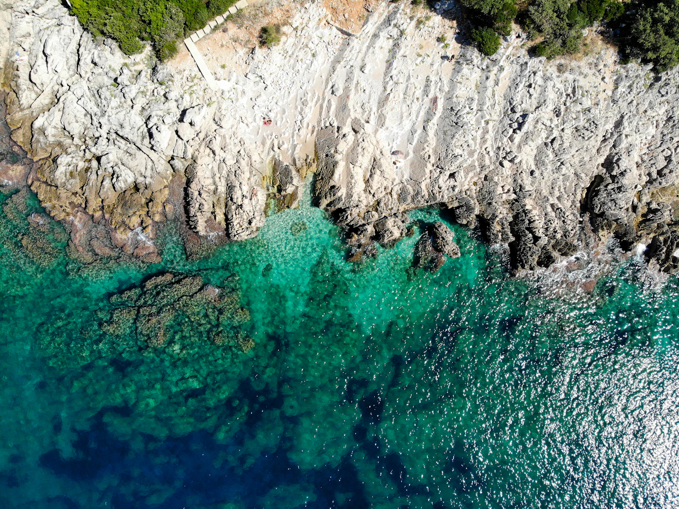 Clear turquoise water meeting the rocky coastline near Dubrovnik